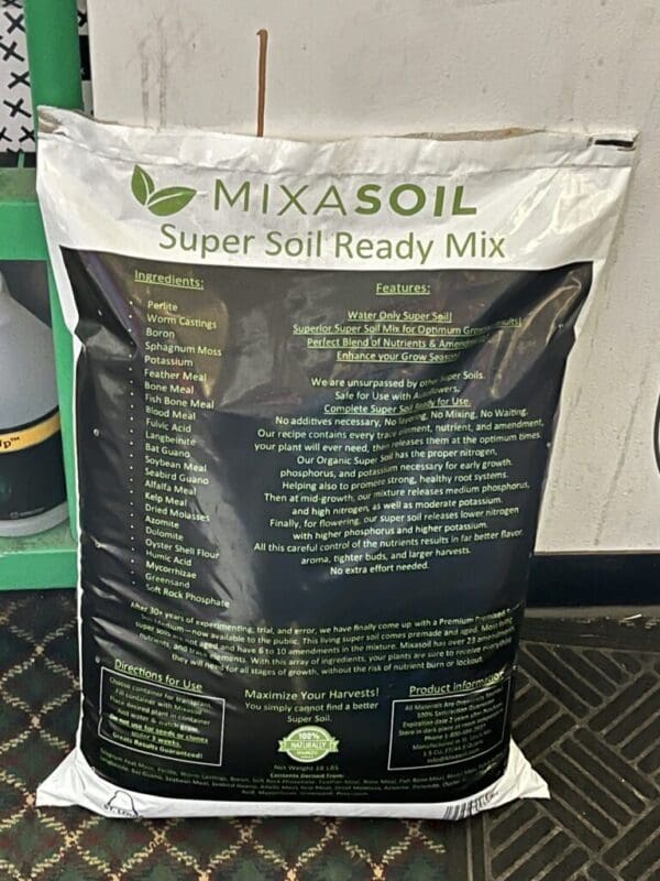 A bag of mix soil sitting on top of a floor.